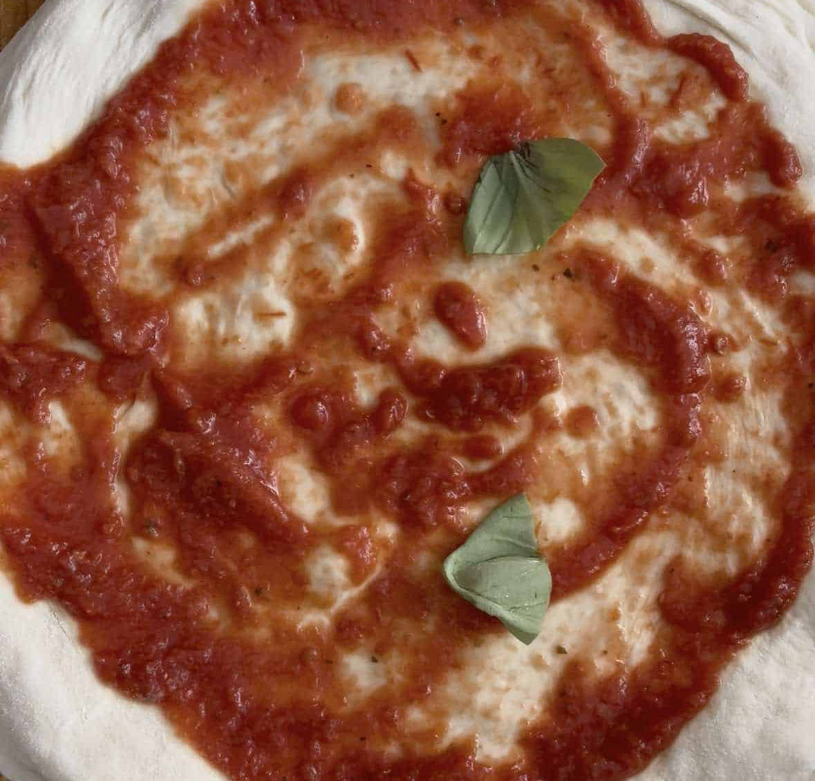 Pizza base with tomato sauce